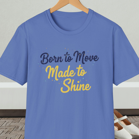 Blue t-shirt with 'Born to Move, Made to Shine' text, on a hanger against a white wall.
