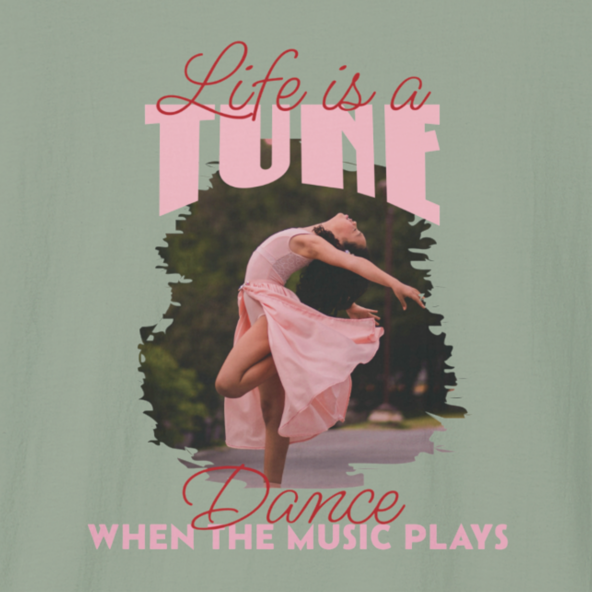 Close-up of a sage green T-shirt with a dancer in a pink dress and text 'Life is a tune, dance when the music plays'