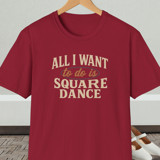 Dark red t-shirt with text 'All I Want to do is Square Dance' on a hanger against a neutral background.
