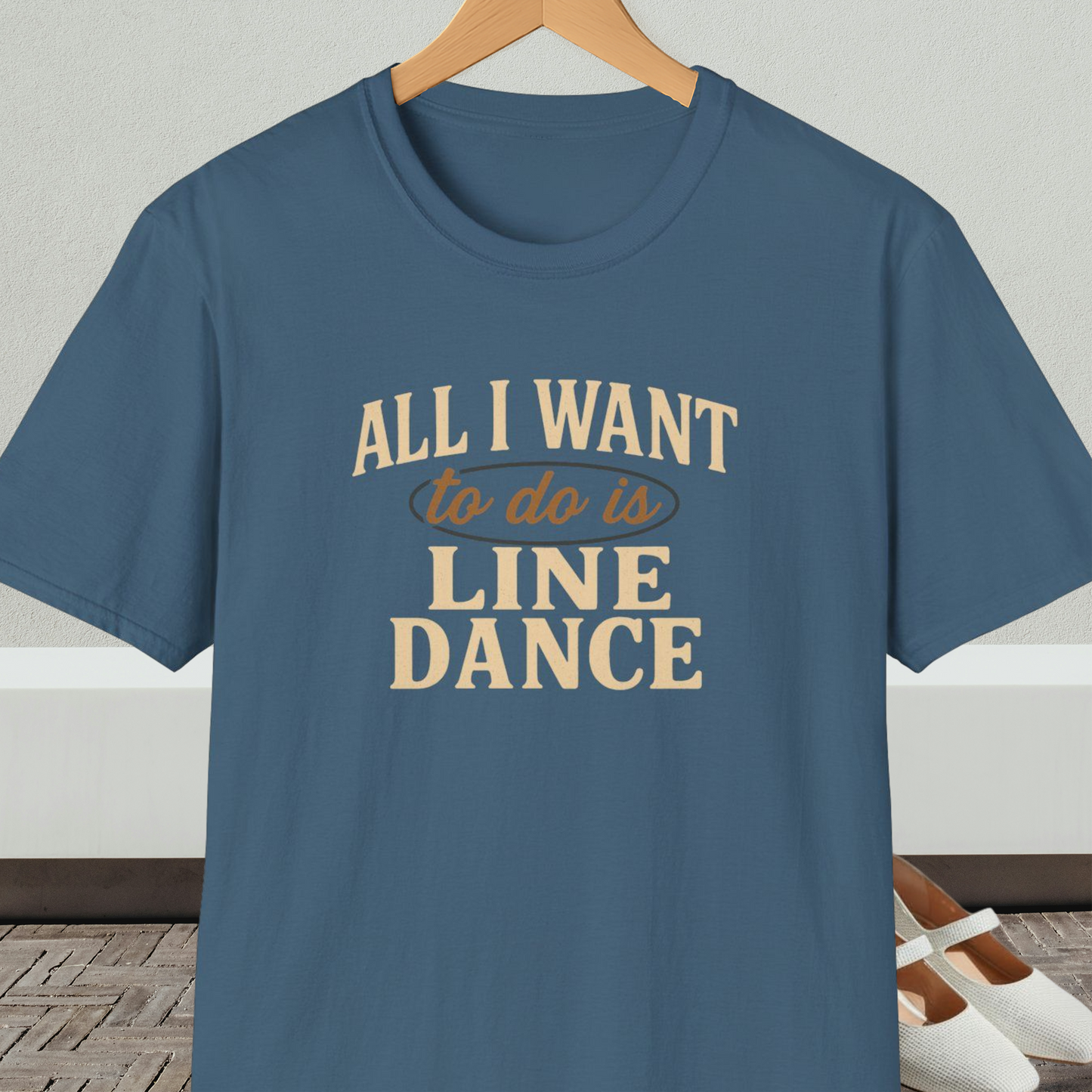 Steel blue t-shirt with 'All I Want to do is Line Dance' text, on a hanger against a neutral background.