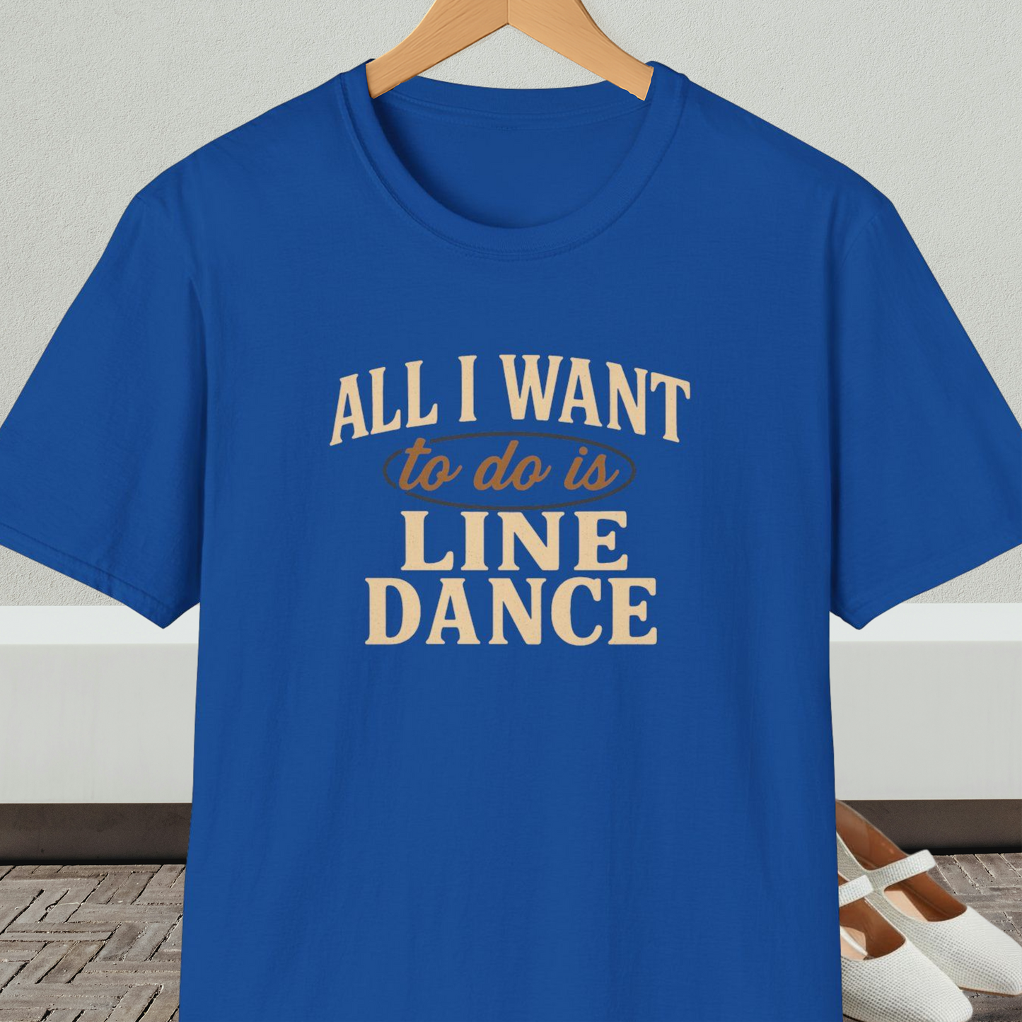 Royal blue t-shirt with 'All I Want to do is Line Dance' text, on a hanger against a neutral background.