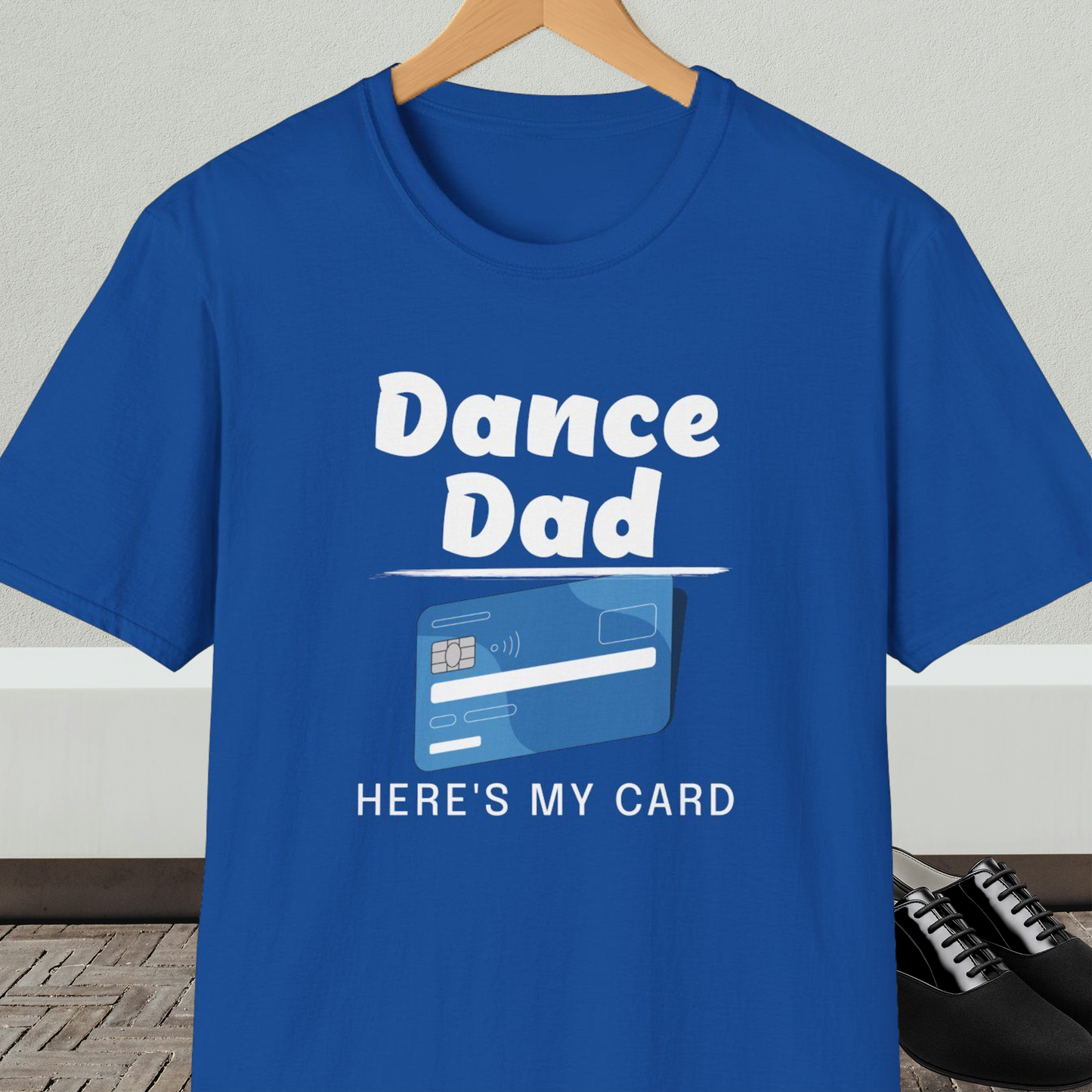 Royal blue t-shirt with 'Dance Dad, Here's My Card' text and credit card graphic, on a hanger with a neutral background.