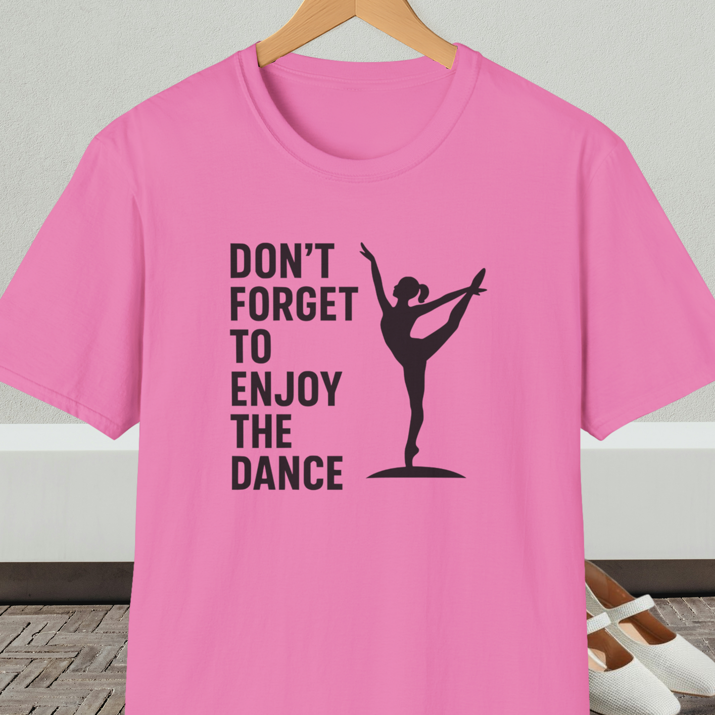 Pink t-shirt with a black silhouette of a dancer and text 'Don't Forget to Enjoy the Dance'