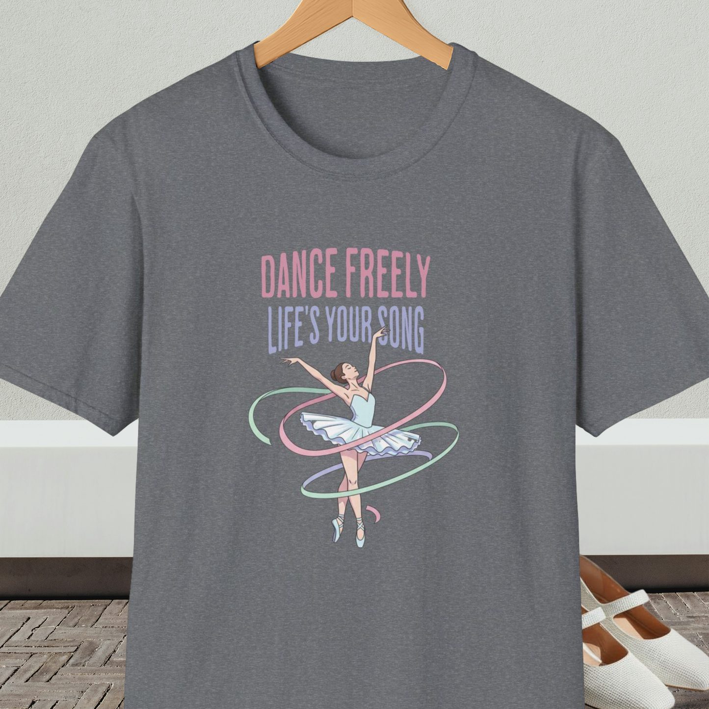 Gray t-shirt with ballet design and text 'Dance Freely Life's Your Song', on a hanger against a neutral background