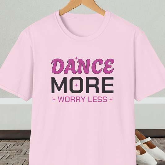Light pink t-shirt with 'Dance More Worry Less' text, on a hanger against a neutral background