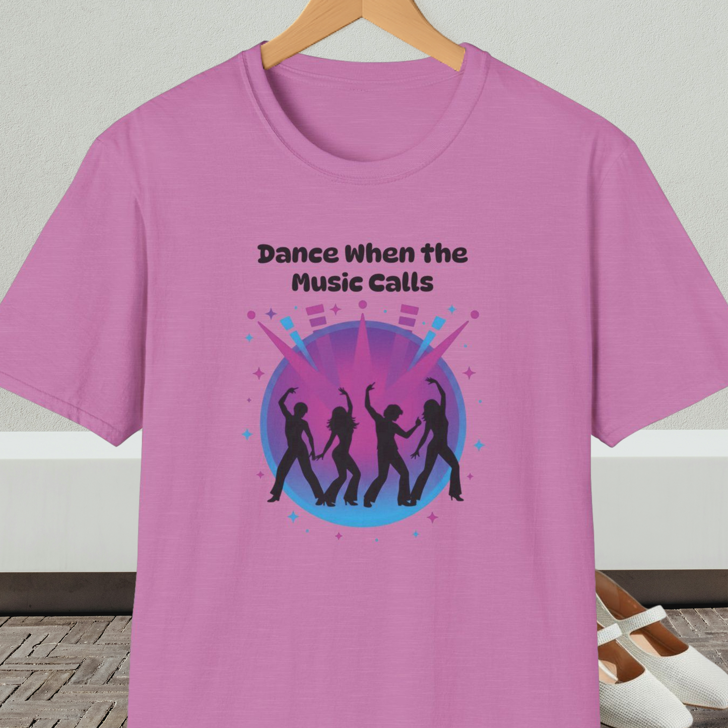 Orchid t-shirt with 'Dance When the Music Calls' dance club design, on a hanger against a neutral background.
