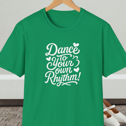 Green t-shirt with 'Dance to Your Own Rhythm!' text, on a hanger against a neutral background.