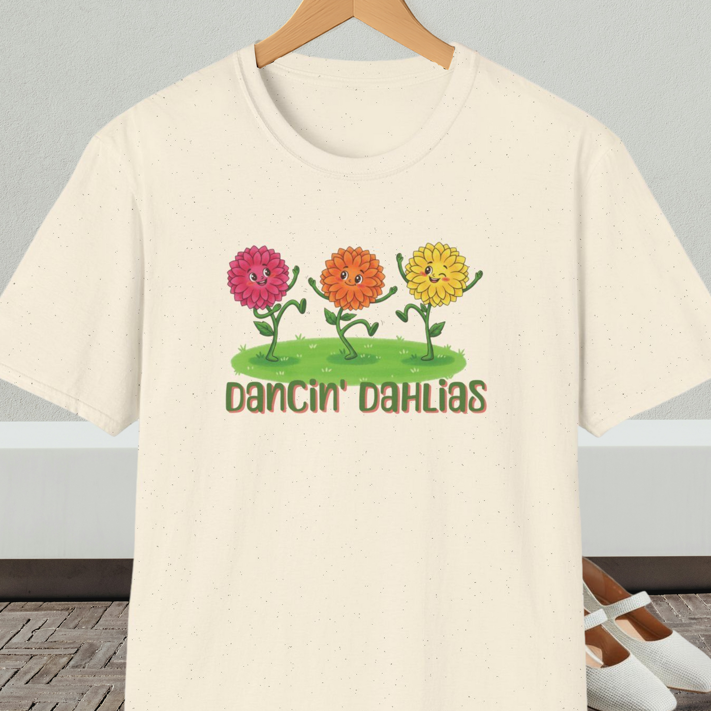 Natural beige t-shirt with 'Dancin' Dahlias' design, on a hanger against a neutral background.