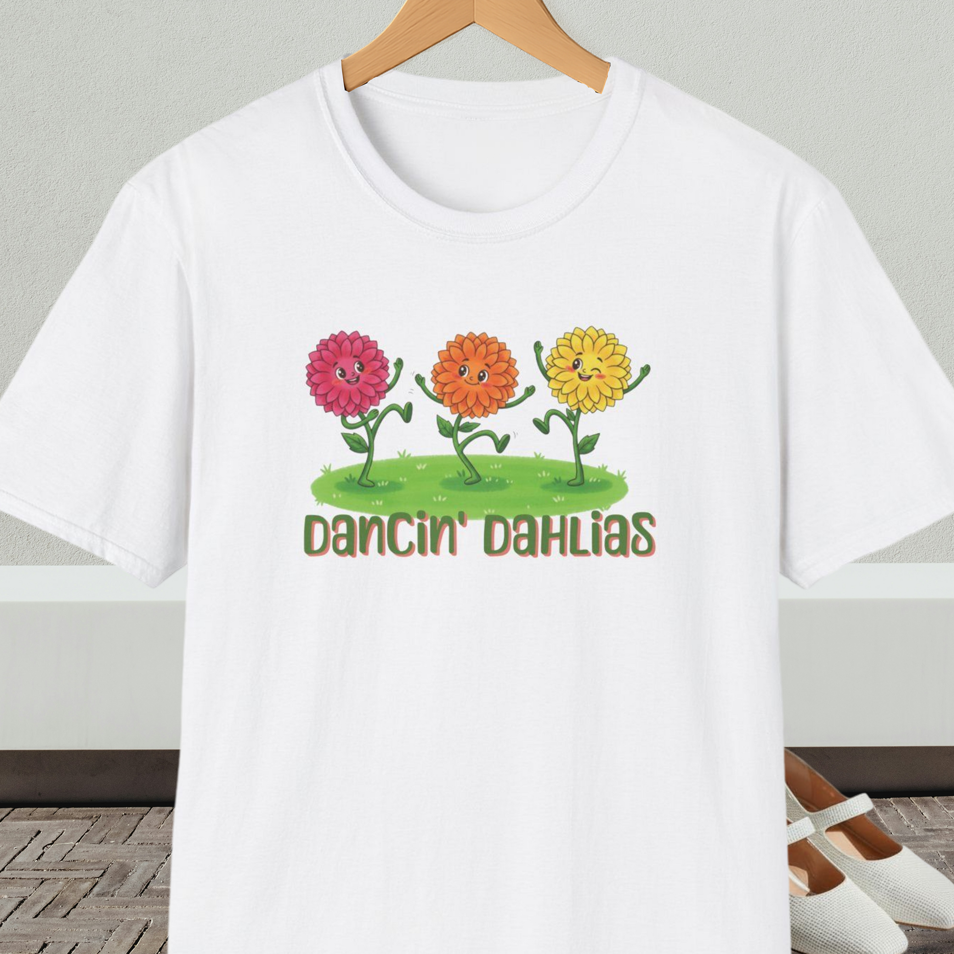 White t-shirt with 'Dancin' Dahlias' design, on a hanger against a neutral background.