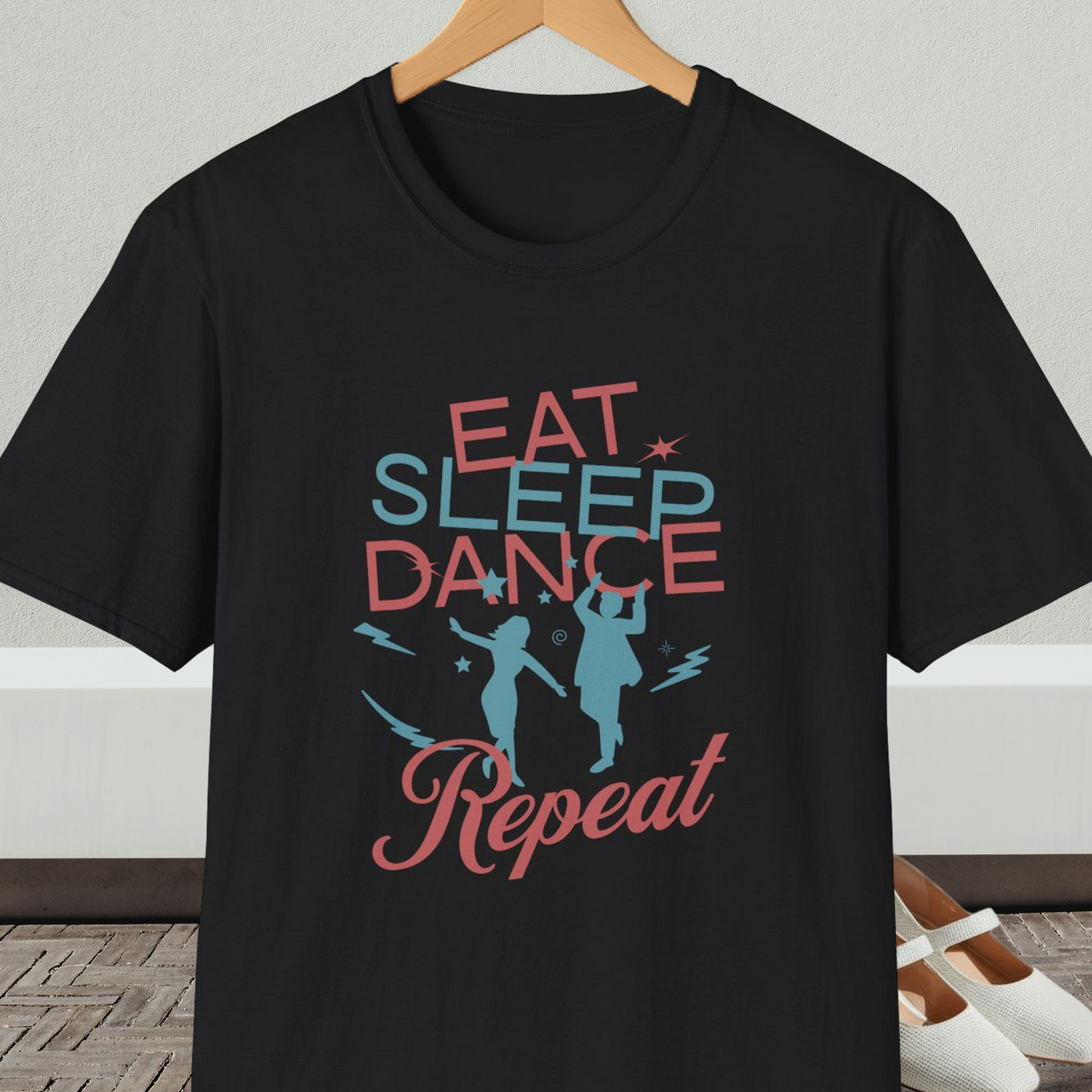 Black t-shirt with 'Eat Sleep Dance Repeat' text and graphics on a hanger.