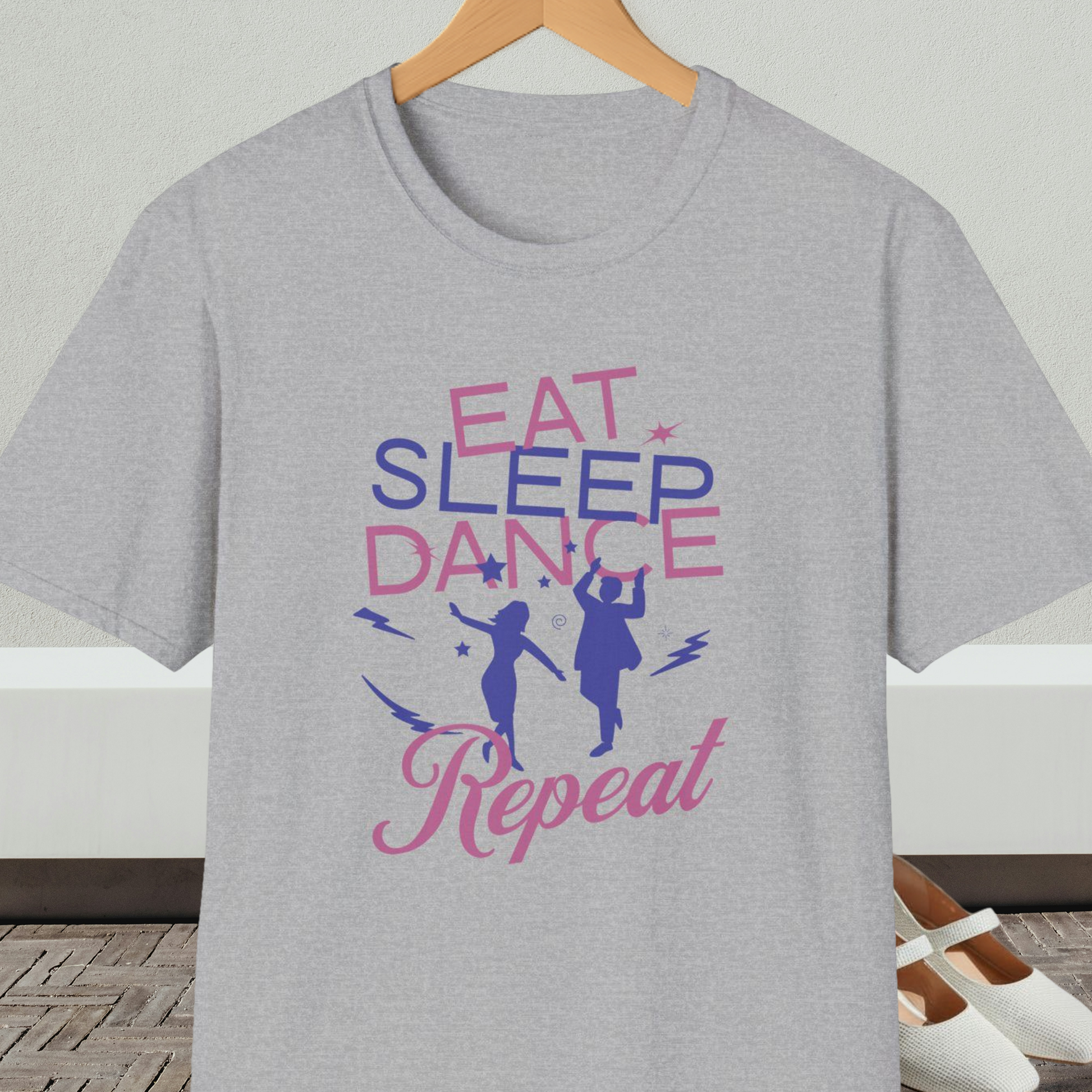 Gray t-shirt with 'Eat Sleep Dance Repeat' text and graphics on a hanger.