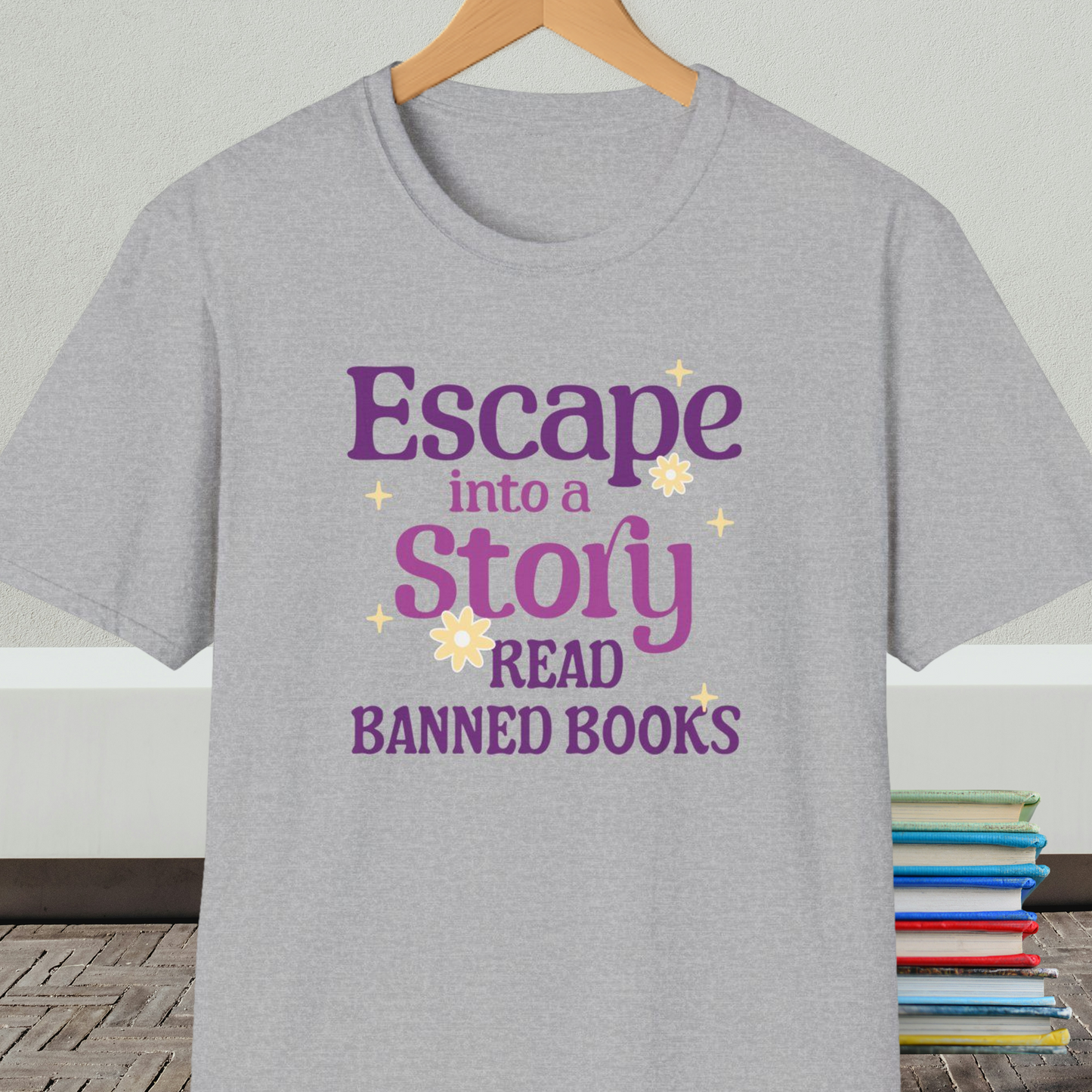 Gray t-shirt on a hanger, with text 'Escape into a Story, Read Banned Books'