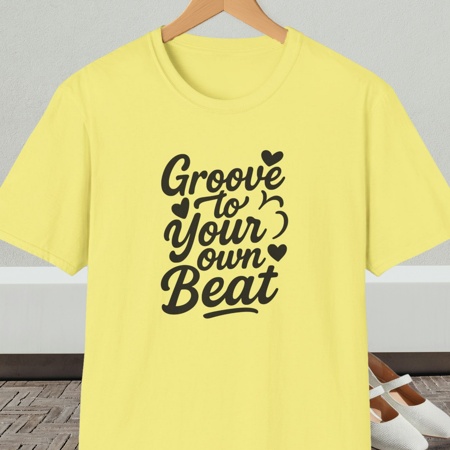 Yellow tee shirt with 'Groove to Your own Beat' in black script letters