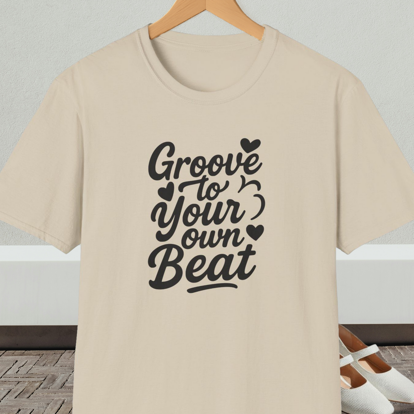 Beige tee shirt with 'Groove to Your own Beat' in black script letters
