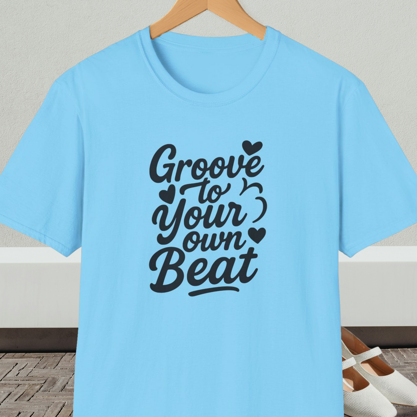 Light blue tee shirt with 'Groove to Your own Beat' in black script letters