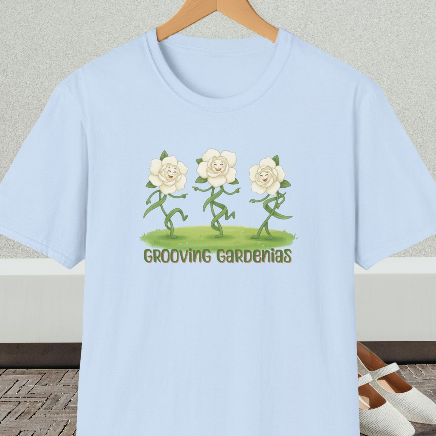 Light blue t-shirt with 'Grooving Gardenias' cartoon graphic and text