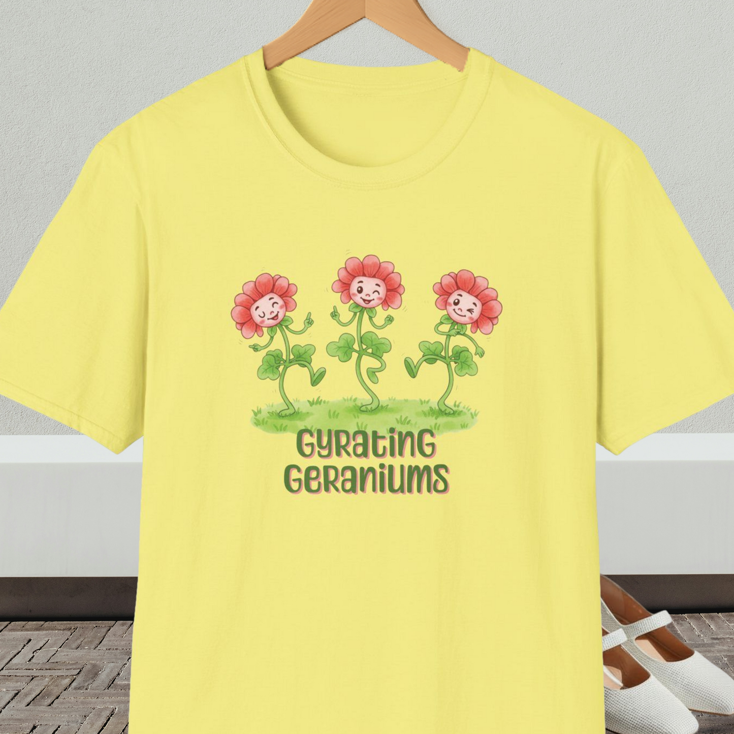 Yellow t-shirt with dancing cartoon flowers and text 'Gyrating Geraniums'