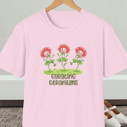 Light pink T-shirt with dancing cartoon flowers and text 'Gyrating Geraniums'