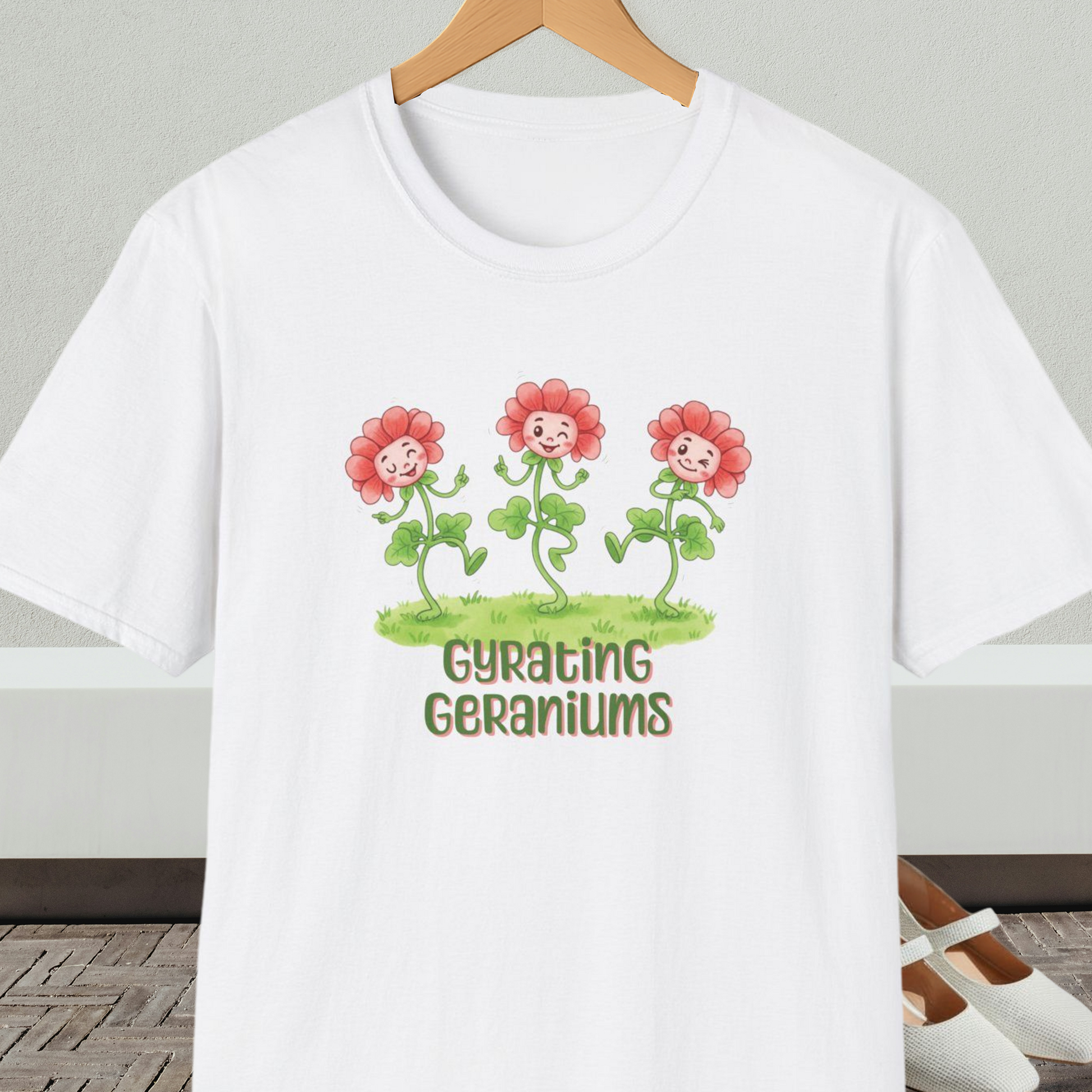 White T-shirt with dancing cartoon flowers and text 'Gyrating Geraniums'