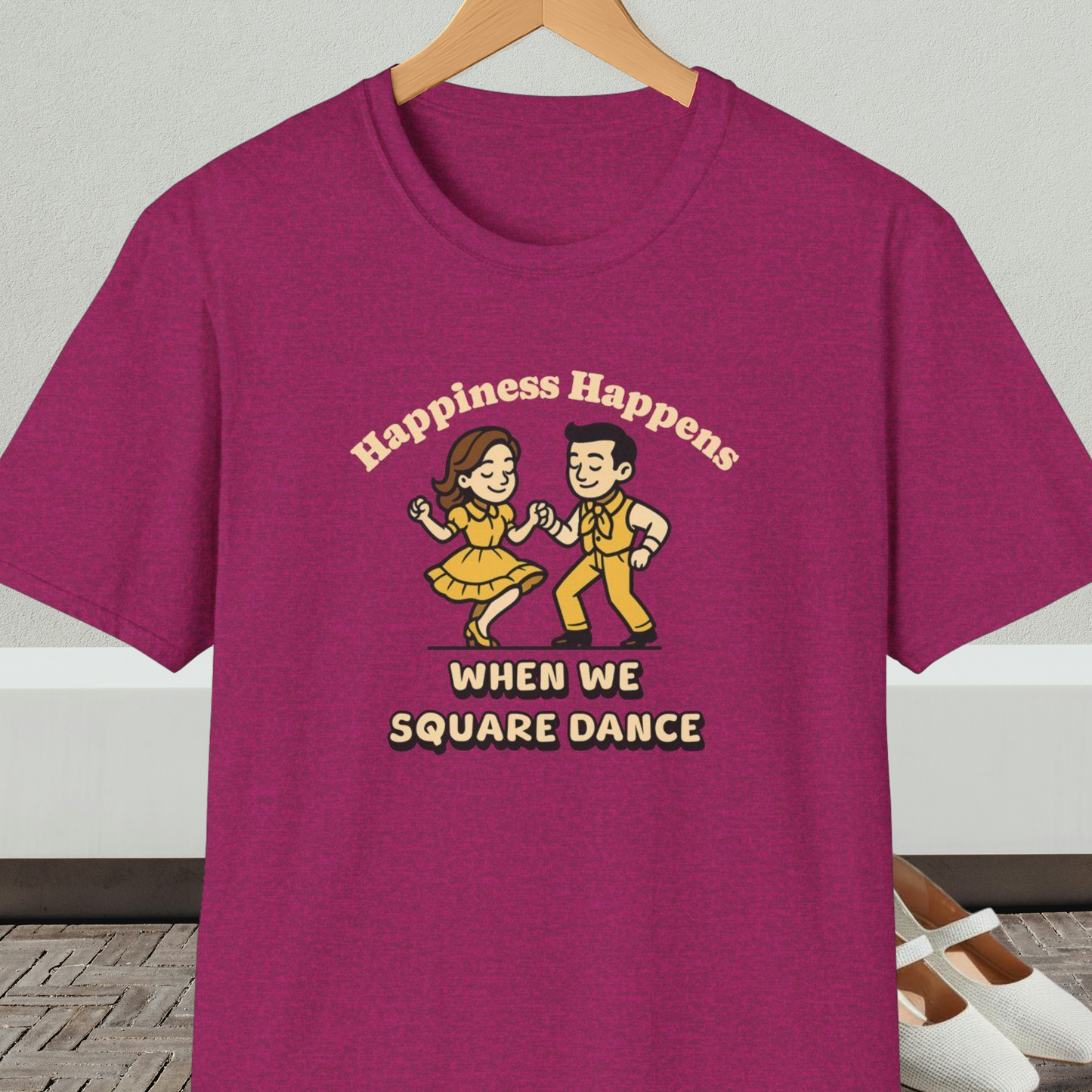 Maroon t-shirt with a graphic of two people square dancing and text 'Happiness Happens When We Square Dance'