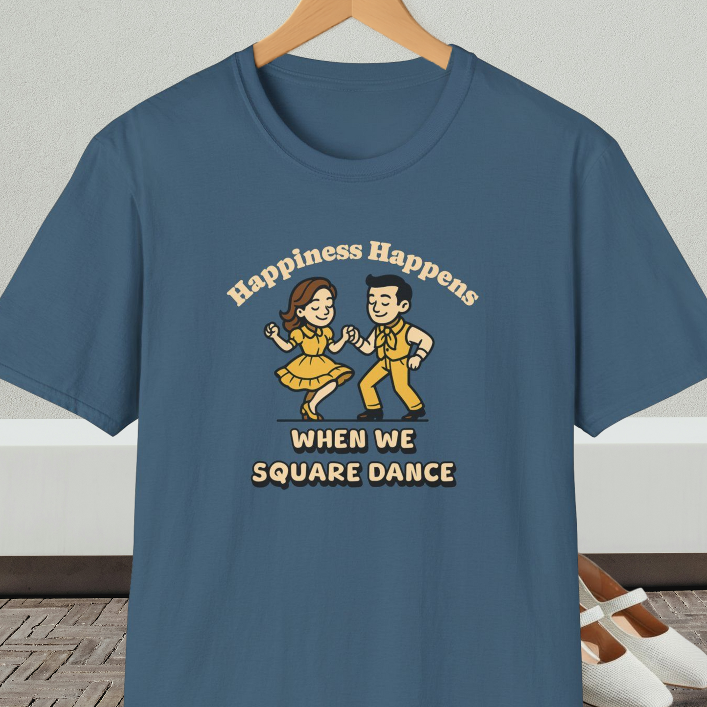 Indigo blue t-shirt with a graphic of two people square dancing and text 'Happiness Happens When We Square Dance'