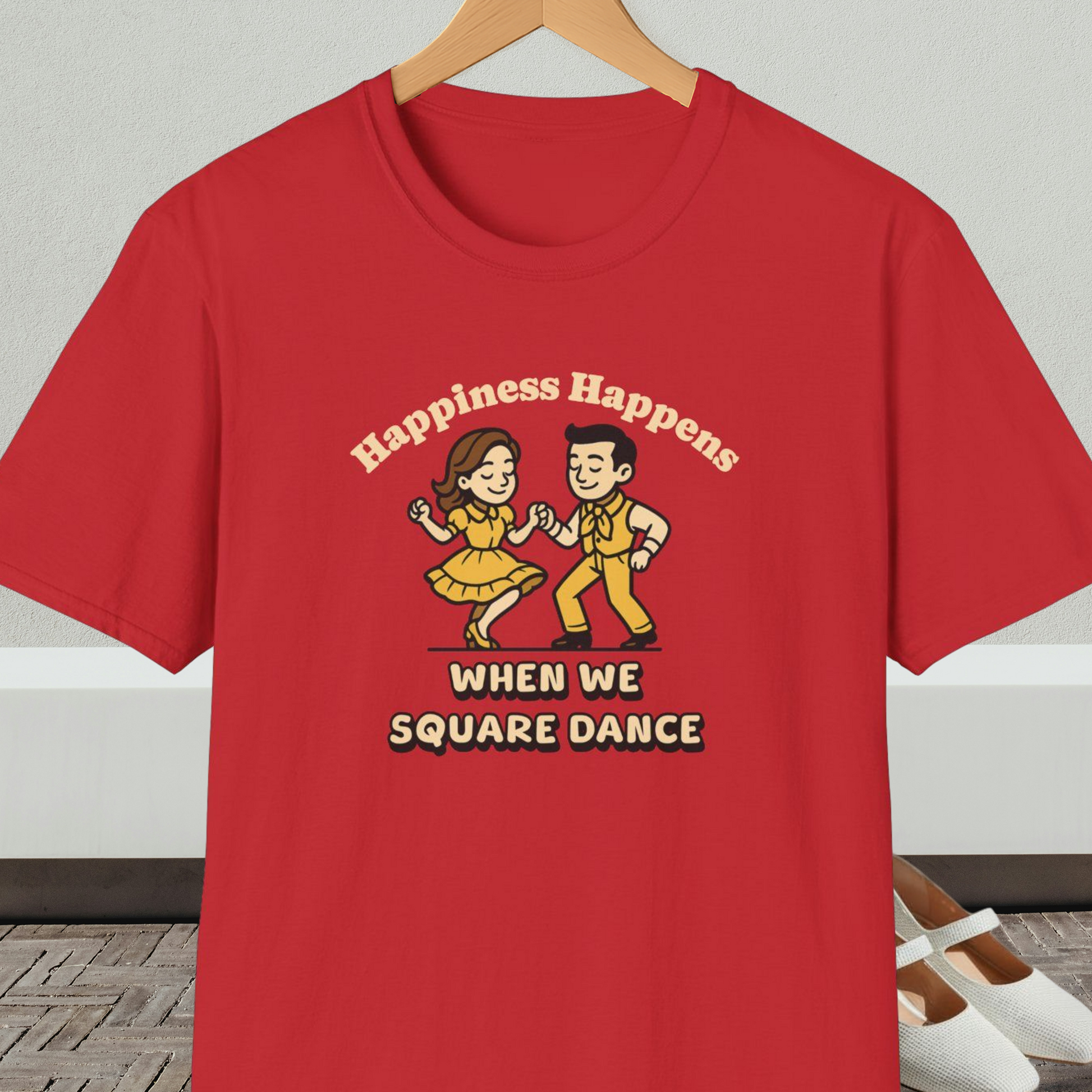 Red t-shirt with a graphic of two people square dancing and text 'Happiness Happens When We Square Dance'