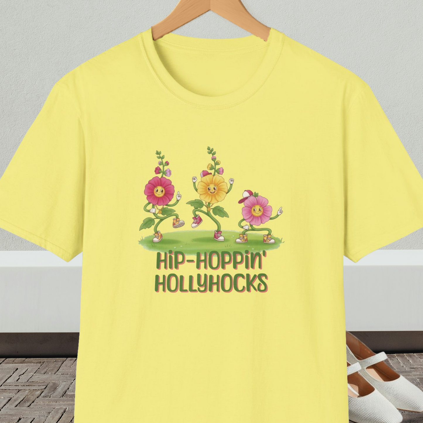 Yellow t-shirt with cartoon dancing floral design and 'Hip-Hoppin Hollyhocks' text 