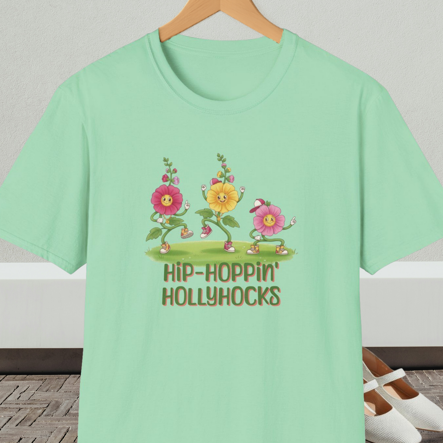 Mint green t-shirt with cartoon dancing floral design and 'Hip-Hoppin Hollyhocks' text 