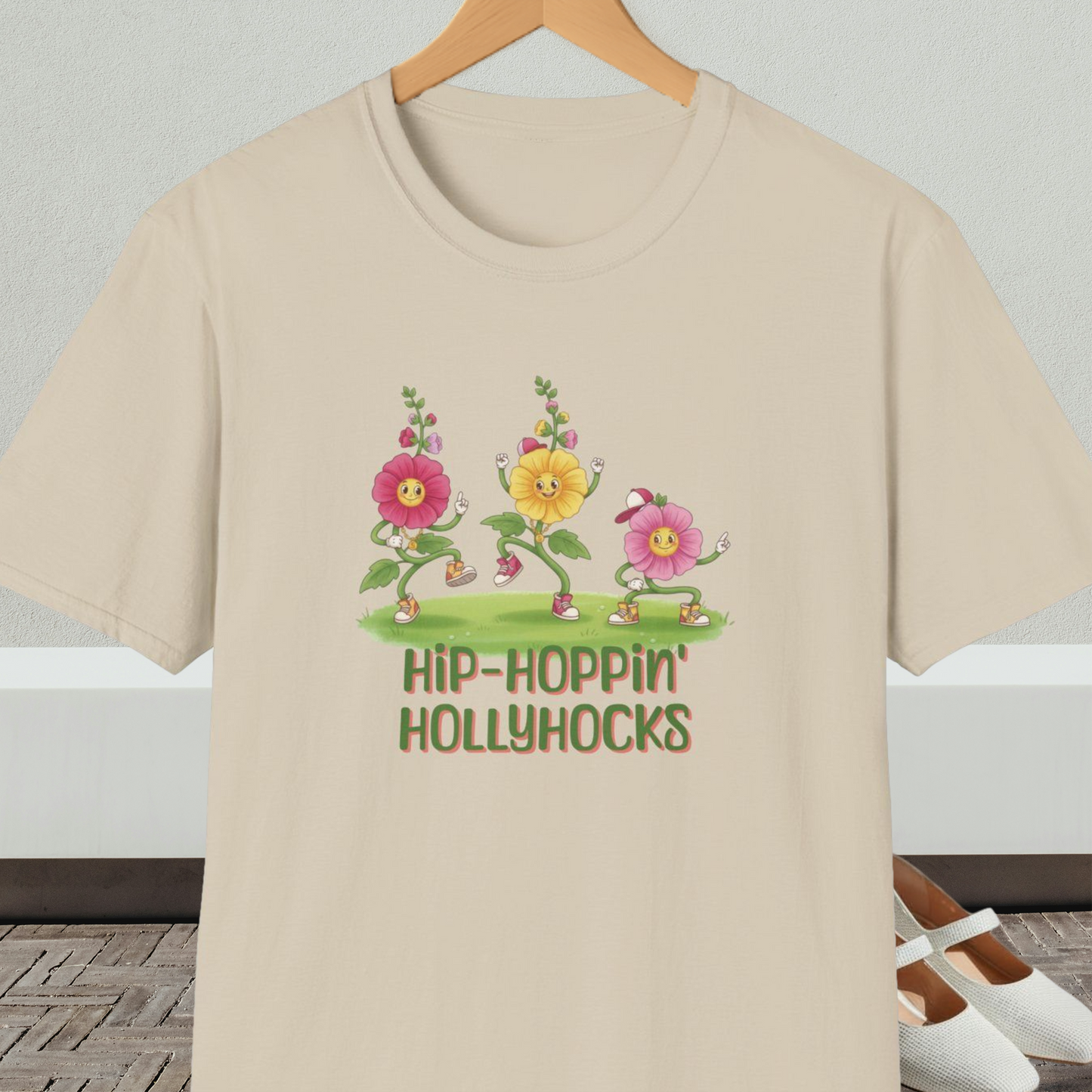 Beige t-shirt with cartoon dancing floral design and 'Hip-Hoppin Hollyhocks' text 