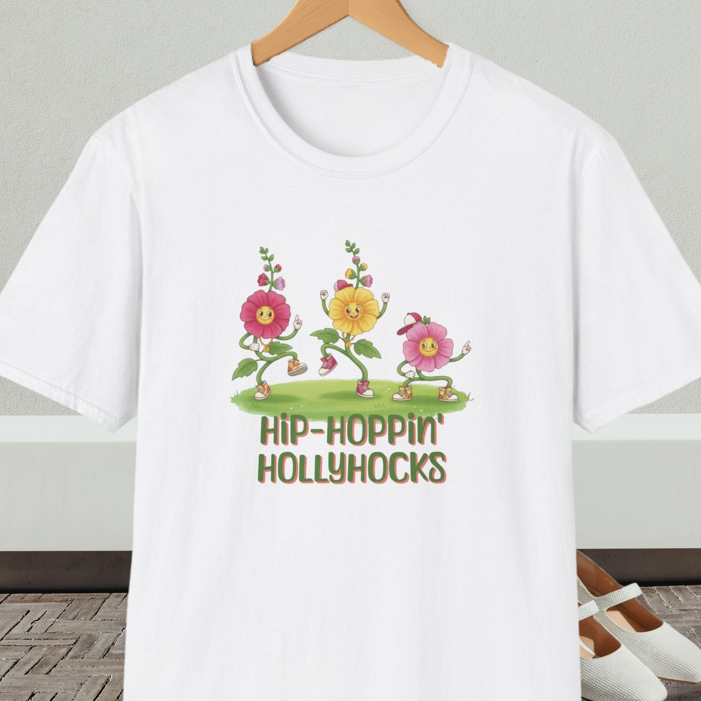 White t-shirt with cartoon dancing floral design and 'Hip-Hoppin Hollyhocks' text