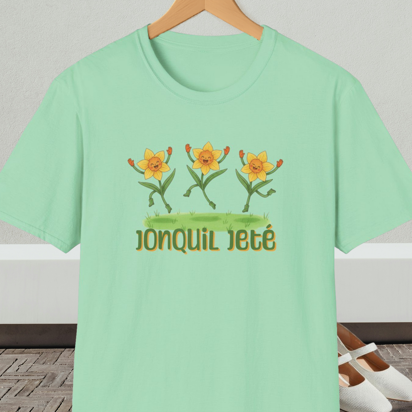 Mint green t-shirt with cartoon dancing jonquils and 'Jonquil Jeté' text.