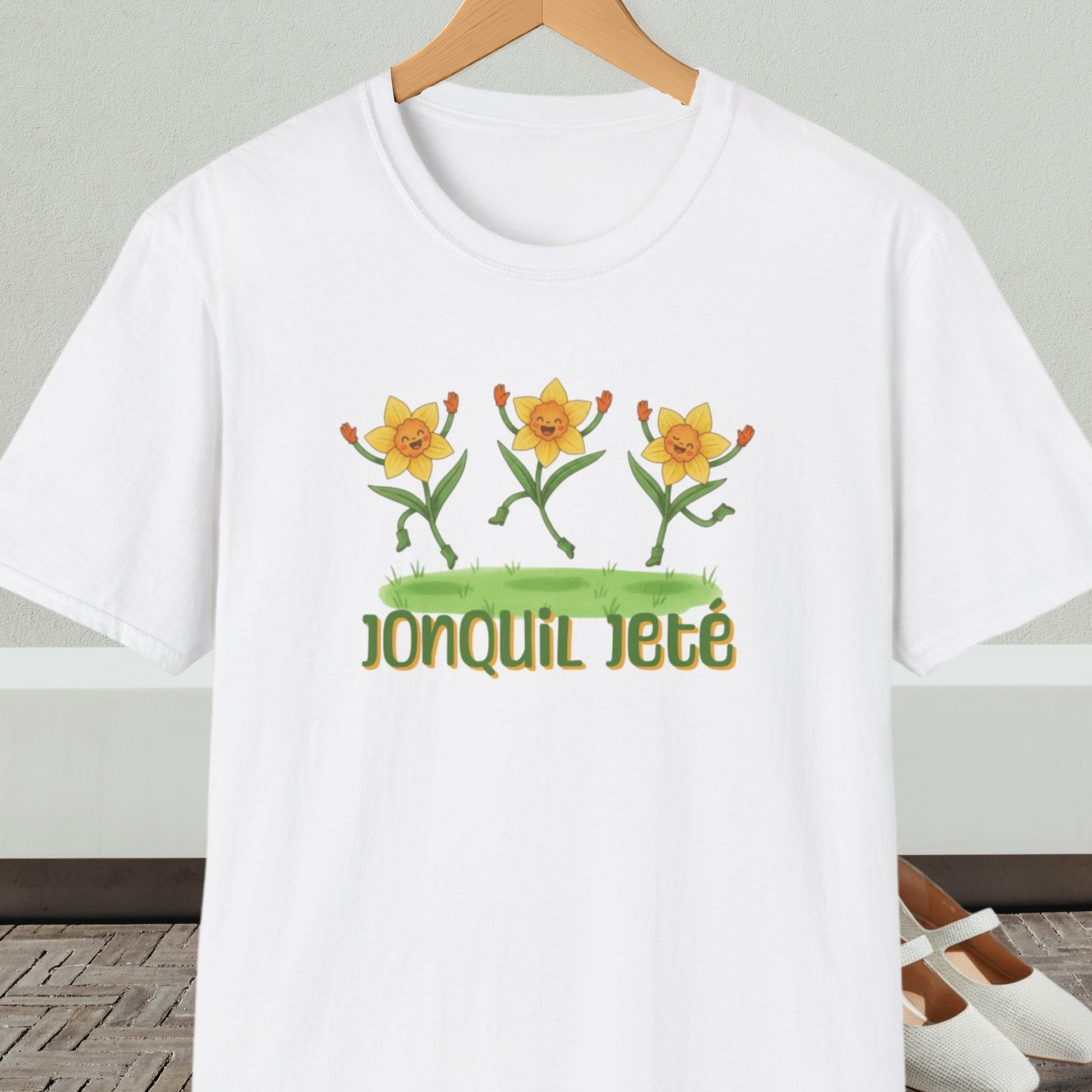 White t-shirt with cartoon dancing jonquils and 'Jonquil Jeté' text.