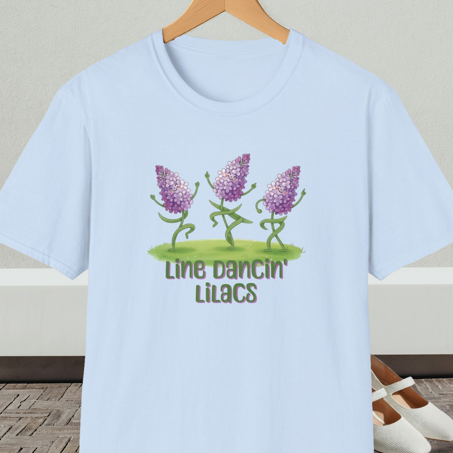 Light blue t-shirt with text 'Line Dancin' Lilacs' and dancing flowers cartoon design.
