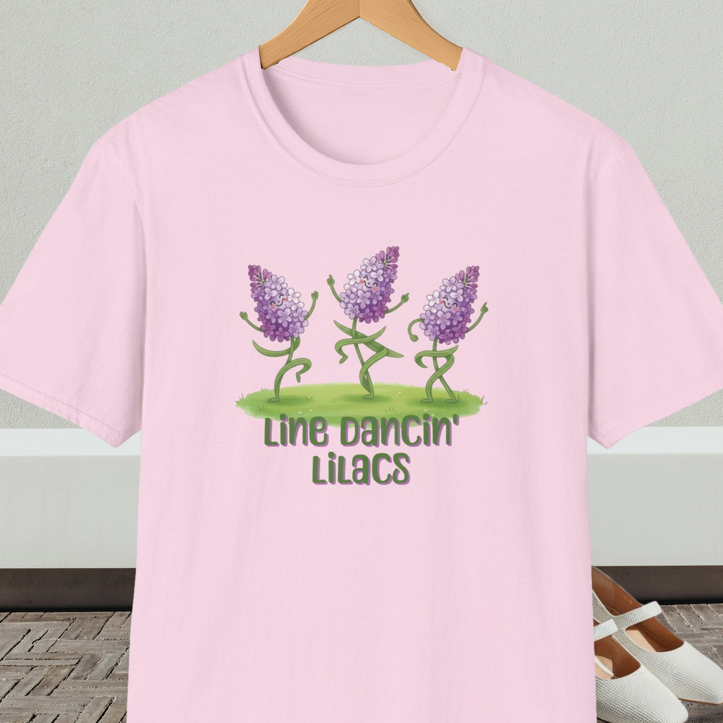 Light pink t-shirt with text 'Line Dancin' Lilacs' and dancing flowers cartoon design.