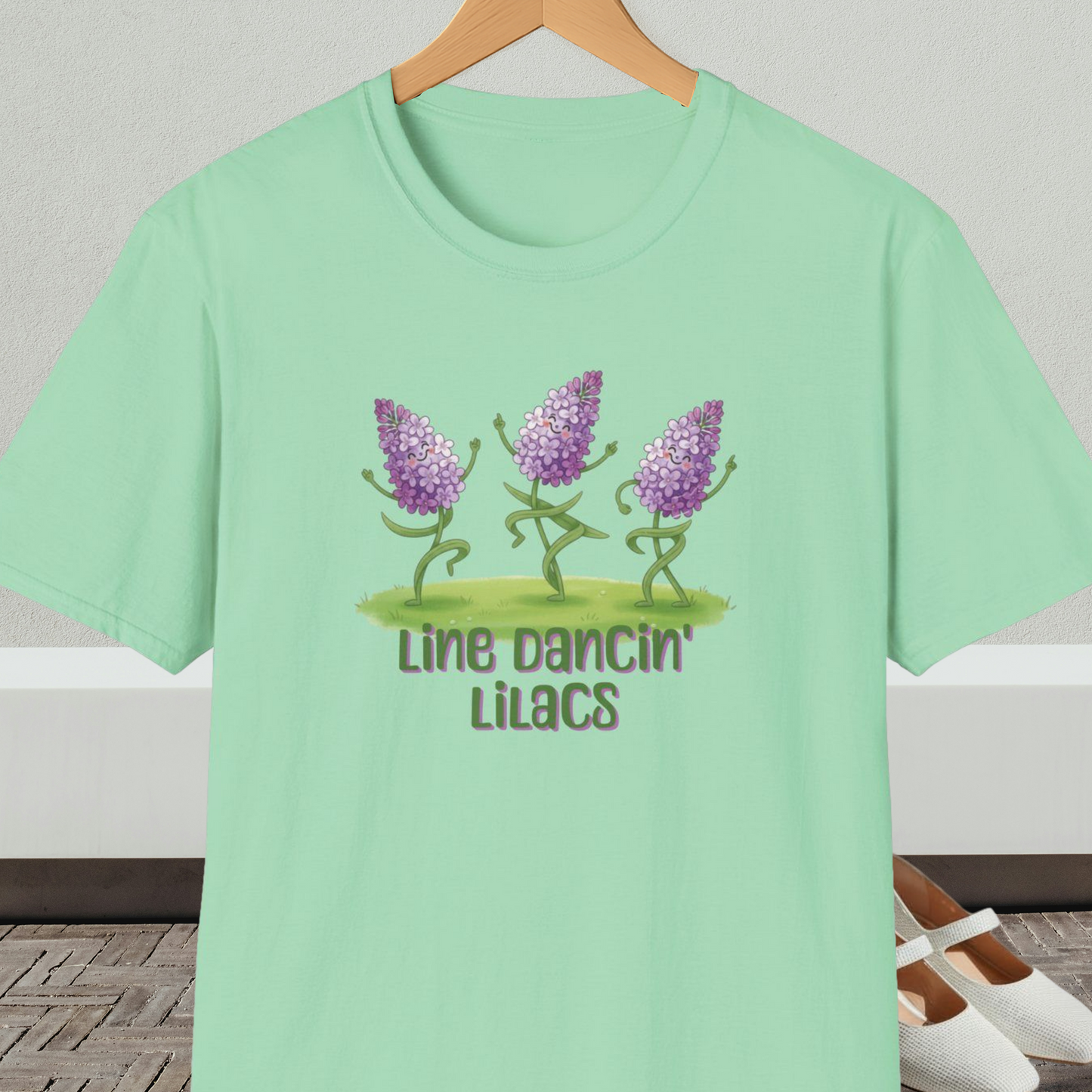 Mint green t-shirt with text 'Line Dancin' Lilacs' and dancing flowers cartoon design.