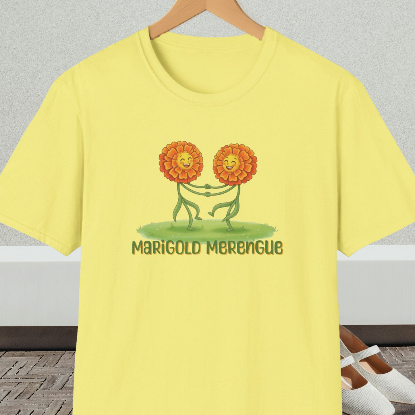 Yellow t-shirt with 'Marigold Merengue' cartoon dancing flowers design