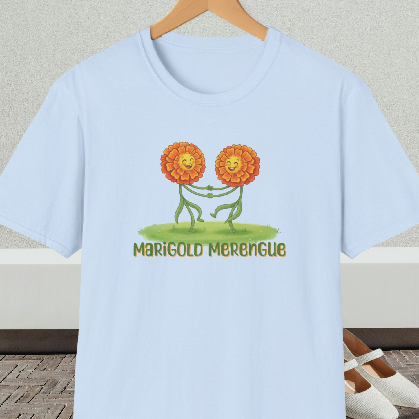 Light blue t-shirt with 'Marigold Merengue' cartoon dancing flowers design