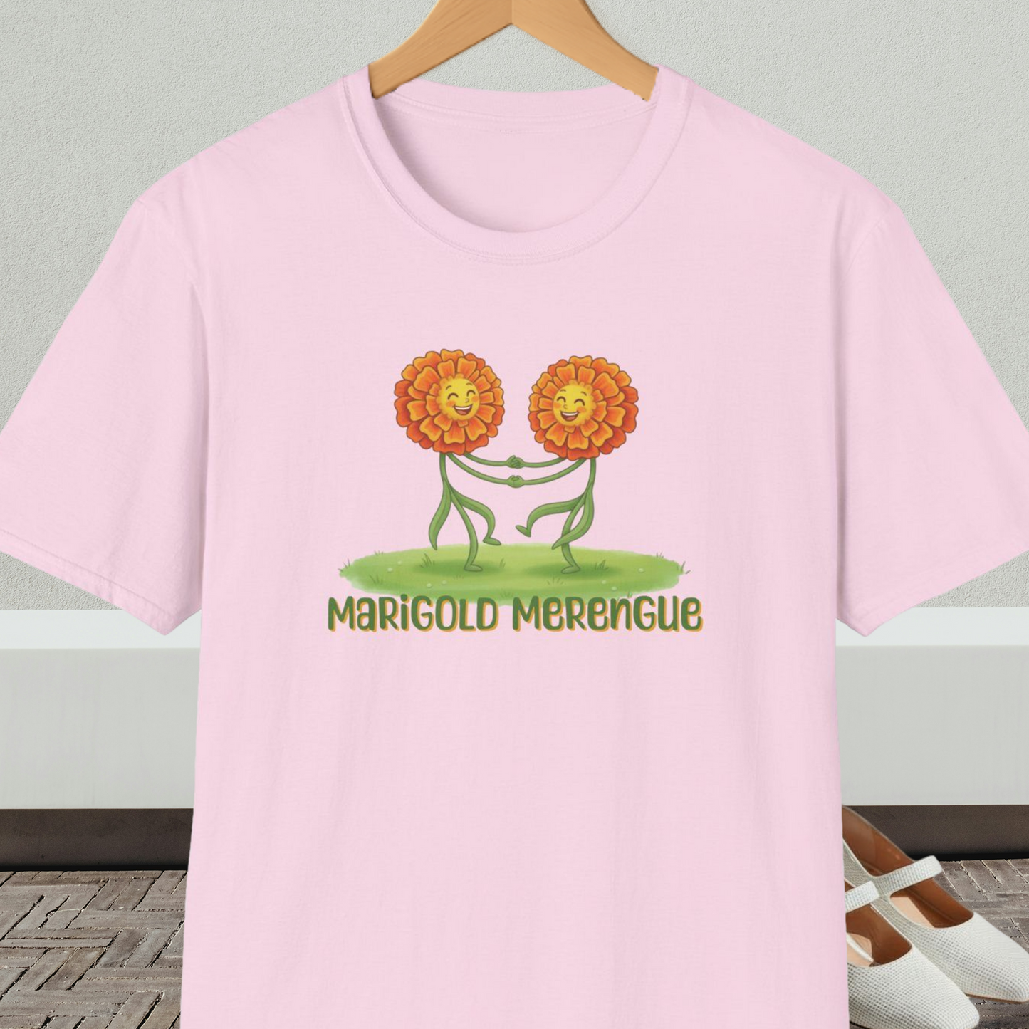 Light pink t-shirt with 'Marigold Merengue' cartoon dancing flowers design