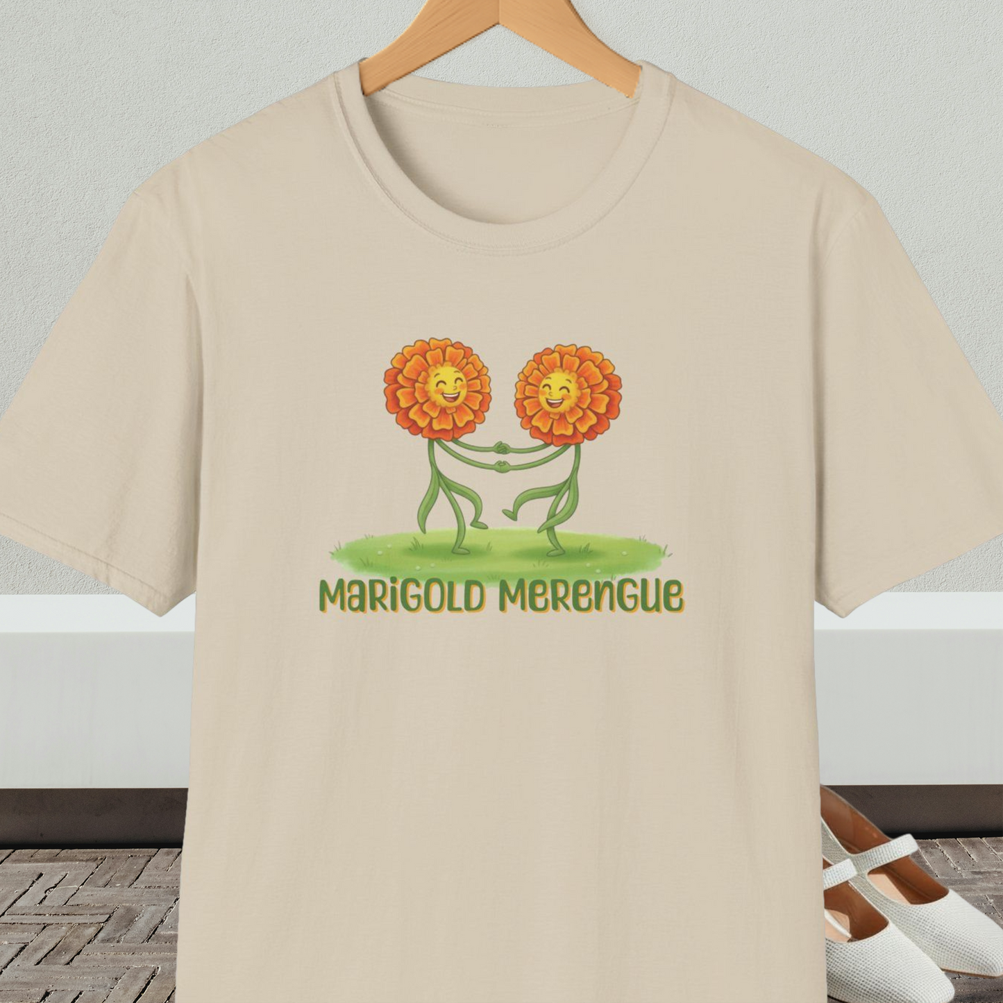 Beige t-shirt with 'Marigold Merengue' cartoon dancing flowers design
