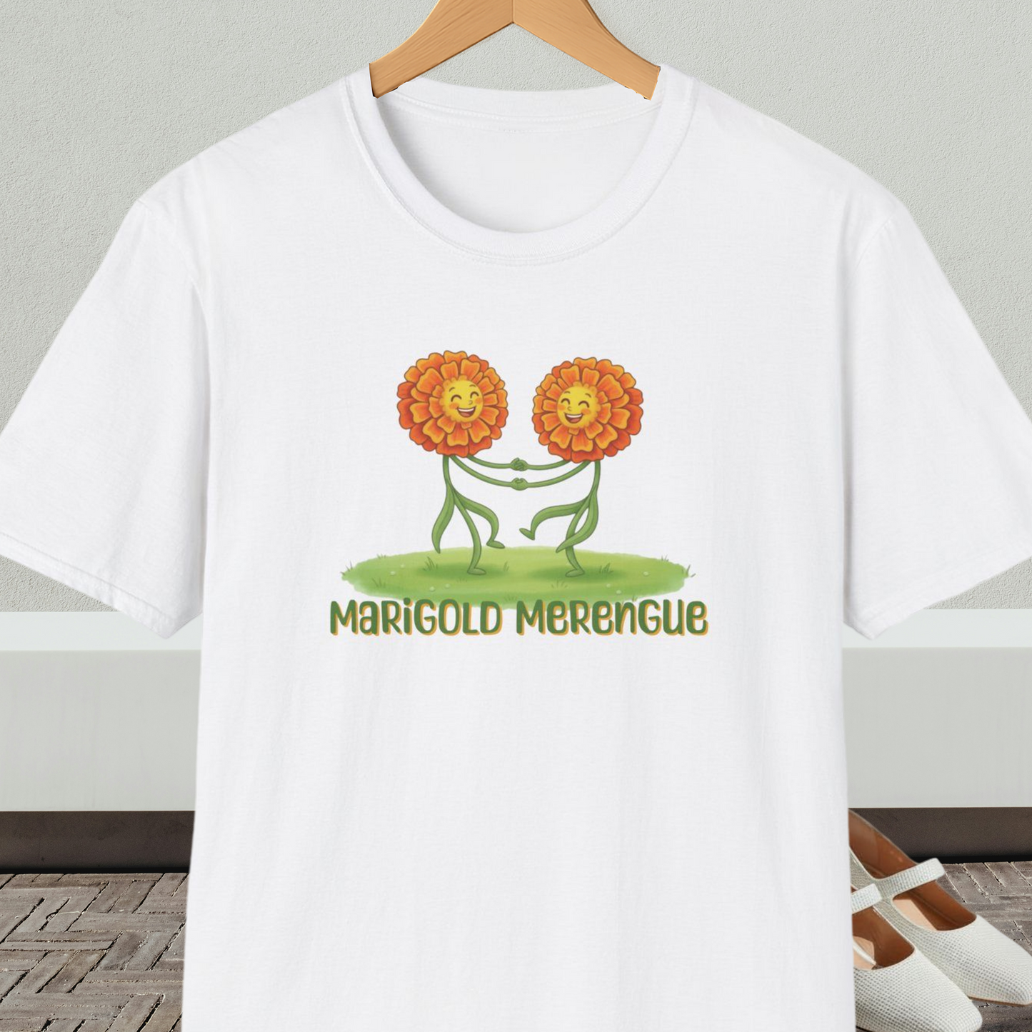 White t-shirt with 'Marigold Merengue' cartoon dancing flowers design