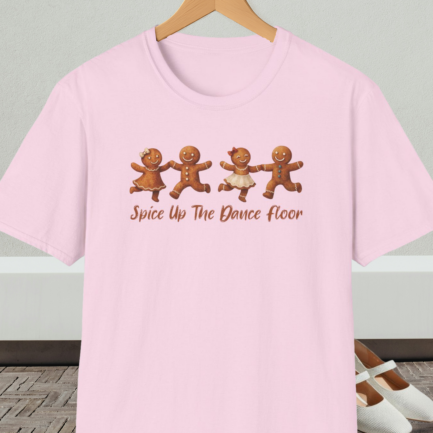 Light pink tee shirt with dancing gingerbread people, with the words 'Spice Up The Dance Floor'
