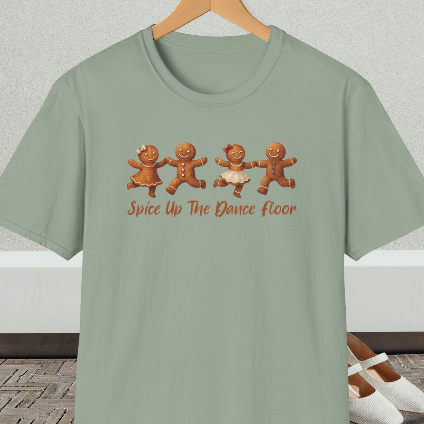 Sage green tee shirt with dancing gingerbread people, with the words 'Spice Up The Dance Floor'