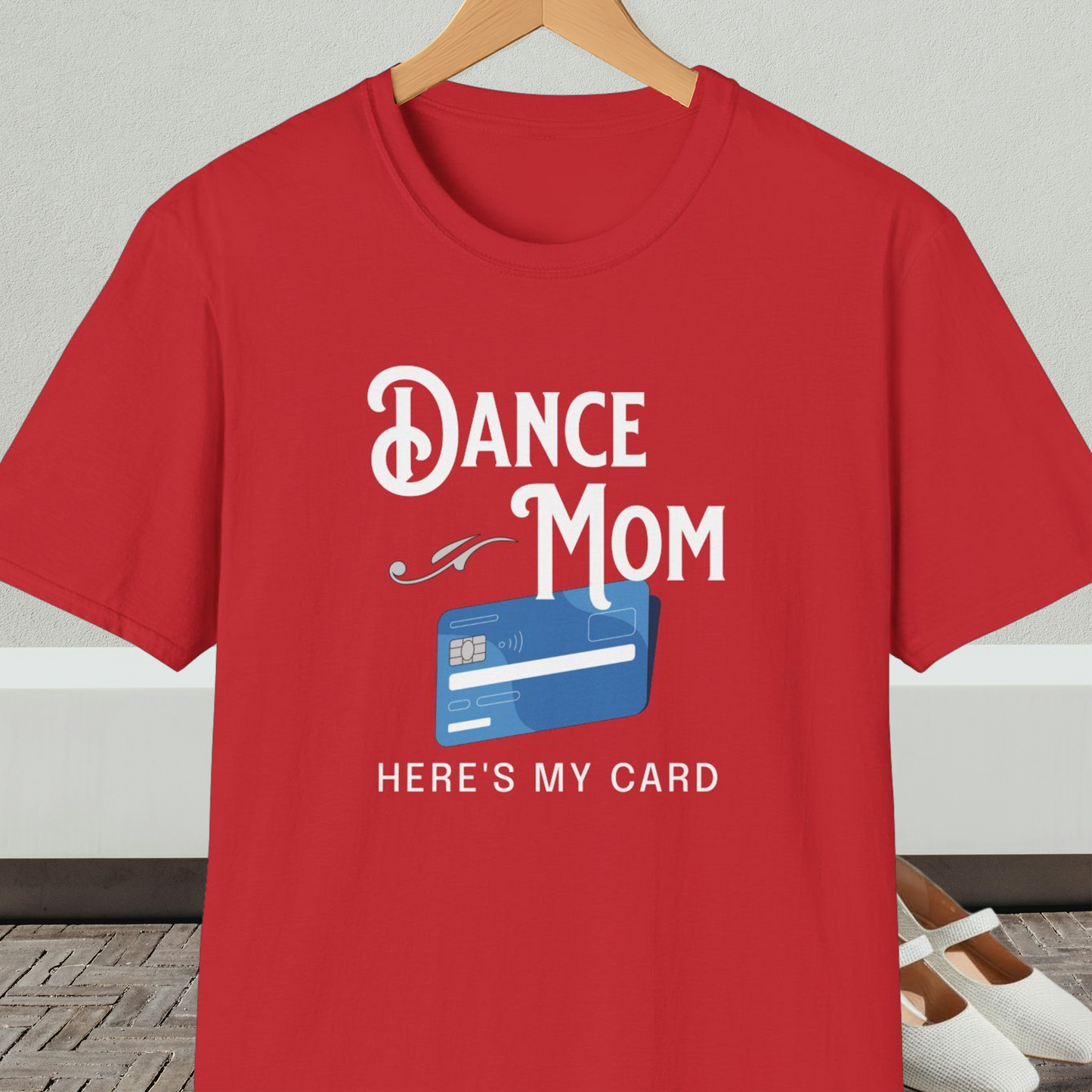 Red t-shirt with 'Dance Mom, Here's My Card' text and credit card graphic, on a hanger with a neutral background.