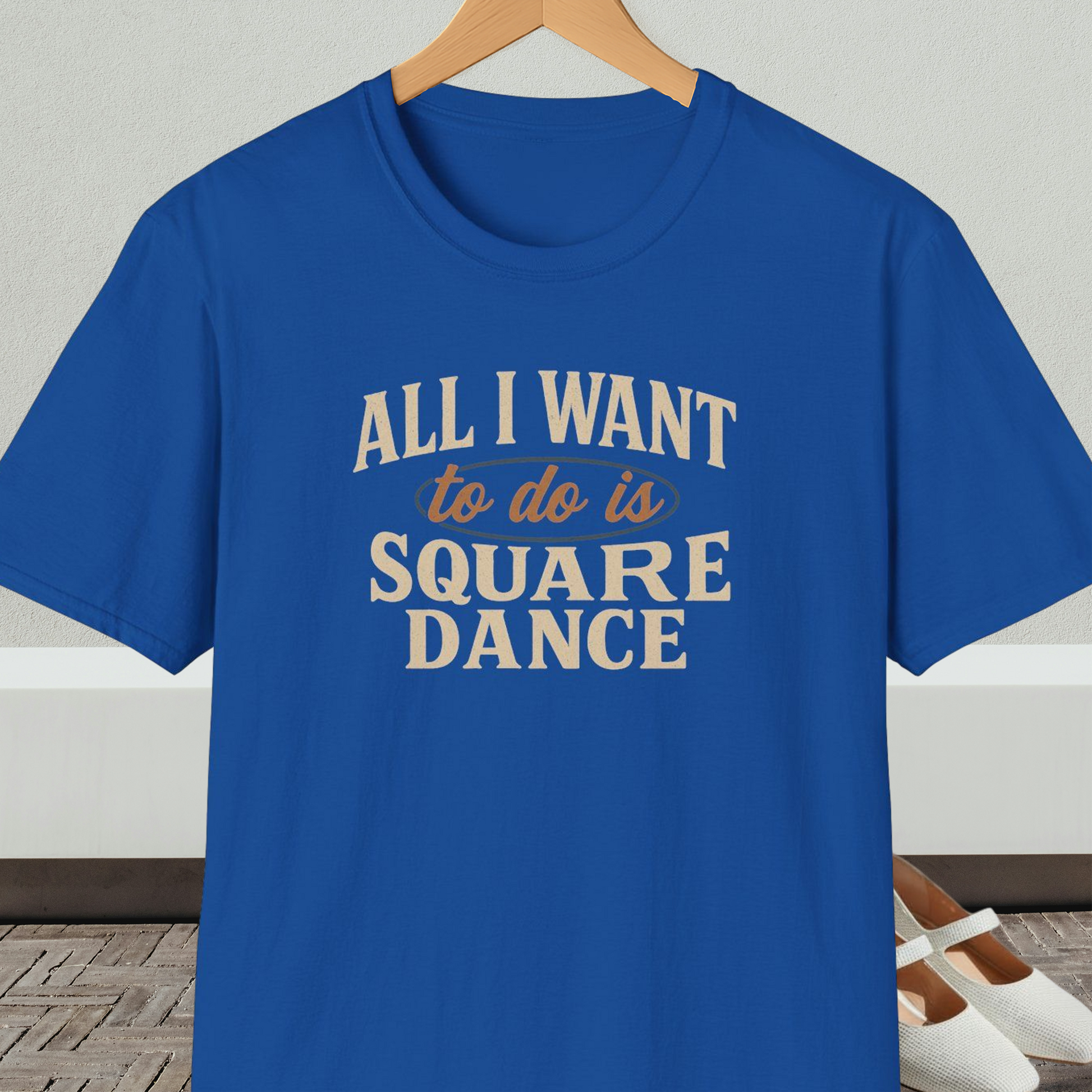 Royal blue t-shirt with text 'All I Want to do is Square Dance' on a hanger against a neutral background.