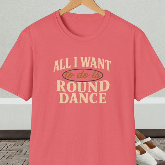 Coral t-shirt with text 'All I Want to do is Round Dance' on a hanger against a neutral background.